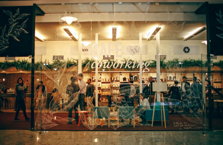 A cozy and bustling indoor coworking space with people engaged in work and conversation.